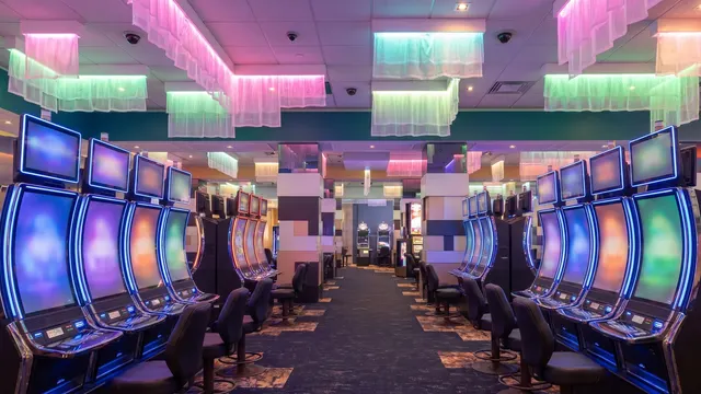 Slot hall at Casino Regina under pink and green lights